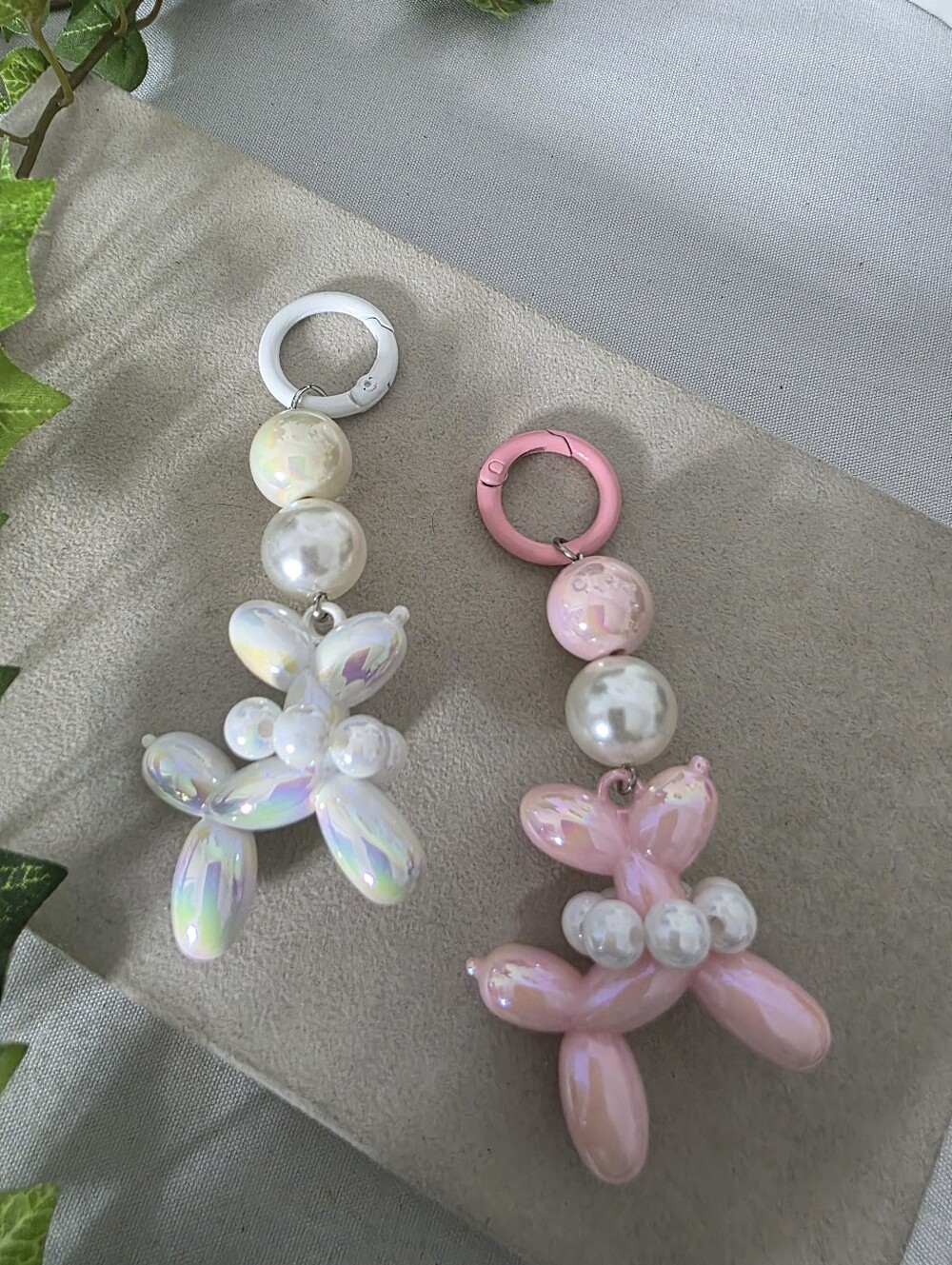 2 Pink And White Iridescent Ballon Dog Keychain